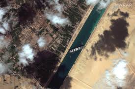 An image released on march 25, 2021 by egypt's suez canal authority shows tug boats alongside the hull of the mv ever given container ship, which was stuck across the canal for a third day. Ykximm4ydb Rwm