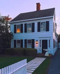 Interestingly, this home's exterior trim is a darker blue which is unusual given many homes opt for a white trim. Traditional 2 Story White Siding Black Shutters Colonial House