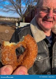 Grandpa Eating an Apple Cider Donut Stock Photo