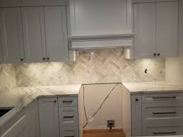 Tiling a backsplash is a give thought when selecting the right tile for your backsplash. Crooked Marble Herringbone Backsplash Install Acceptable