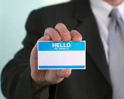 Image of person holding up a name tag
