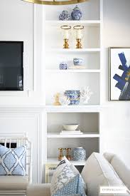 Paint or wallpaper the back shelves for a pop of color and visual interest. How To Decorate Bookshelves For Spring Citrineliving