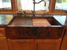 copper sink with black countertop