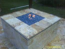 We have everything you are looking for! Custom Gas Fire Pit With Blue Fire Glass And Marble Stone Pavers And Remote Controlled Valve Glass Fire Pit Fire Pit Designs Fire Pit Materials