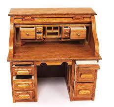 32 inches wide, 30 inches high at desk level, 45 inches high total… Miniature Oak Roll Top Desk