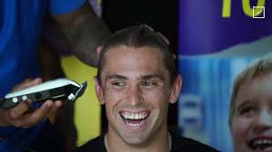 Aaron Booth shaves his head for the Starlight Foundation