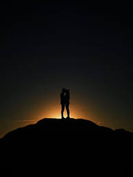 Couple walking on the beach at sunrise with cromatic umbrella and beautiful colors in background. Royalty Free Photo Silhouette Of Man And Woman Beside Body Of Water Pickpik