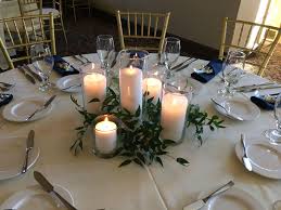 Ruscus Greenery Centerpiece With Assorted Pillar Candles Pillar Candle Centerpieces Candle Wedding Centerpieces Simple Candle Centerpieces