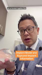 Dr. Kenneth Lee, a board-certified plastic and reconstructive surgeon with  Orlando Health Aesthetic and Reconstructive Surgery Institute, demonstrates  a model of a silicone implant and explains why ...