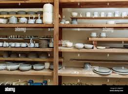Handmade Ceramic Pottery In A Potter S Workshop Clay Plates Mugs And Teapots On The Shelves In The Workshop Studio Stock Photo Alamy