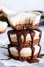 Three Raw Vegan Tiramisu Bites On Top Of Each Other The Bottom Two Are Generously Drizzled With Melted Chocolat Vegan Tiramisu Raw Vegan Desserts Raw Desserts