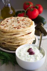 Take the hot trays from the oven, dust with flour and lay the pittas on them. Greek Pita Bread Recipe Easy And Tasty Philosokitchen
