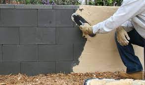 To stucco a cinder block wall, apply a concrete bonding agent, apply scratch layer of stucco and then add a finishing coat of stucco, allowing 36 to 48 hours for curing between each layer. Build A Concrete Block Wall The Easy Way With Quikrete Quikwall Today S Homeowner