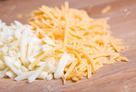 The very basic and main difference is the difference in color between the two. Yellow And White Cheddar Cheese Grated On A Wood Cutting Board Stock Photo Picture And Royalty Free Image Image 4620858