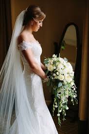 Ditching the typical floral bouquet, a bride decided to carry a bouquet of doughnuts as she walked the aisle along with her bridesmaids. Large Elegant White Blossom Bridal Bouquet