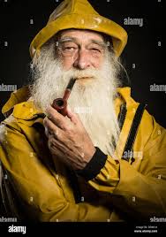 Vieux Pêcheur avec barbe blanche portant des sou'wester hat et Guy Cotten  veste cirés Photo Stock