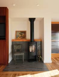 Modern wood stoves are a key feature in all of our homes at hv contemporary homes. Modern Inglenook Pratt Larson Brownstone Tile Modern Wood Stove Morso Plaid Chair Scandina Modern Wood Burning Stoves Wood Stove Loft Living Room Design