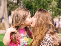 Young Mother And Little Daughter Kissing Outdoors Stock Photo, Picture and  Royalty Free Image. Image 55413262.