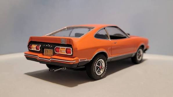 1977 Mustang II Mach 1 from AMT. This was the 2005 issue which is currently  available as the Hell Drivers Mustang. Added wheels, tires and rear spoiler  from an MPC kit. Hood