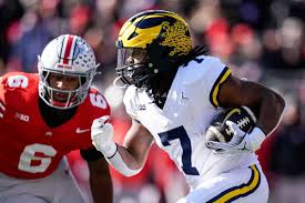 Michigan Wolverines RB Donovan Edwards gaining momentum at Senior Bowl,  showing determination and drive for excellence