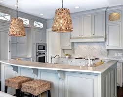 A stainless steel range and oven is flanked by classic white cabinets with nickel hardware. The Psychology Of Why Gray Kitchen Cabinets Are So Popular Home Remodeling Contractors Sebring Design Build