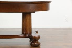 This table has four leaves with a straight apron and rests on round, baluster style legs with carved acanthus leaf ornamentation. Oval Antique Quarter Sawn Oak Coffee Table Base With Columns Bun Feet 36419 Harp Gallery Antiques Furniture