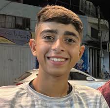 The boy who the Israeli terrorist forces murdered yesterday in Jabalia  before a tank advanced to run over him was named Zaher Shamiyya. He was 16  years old.