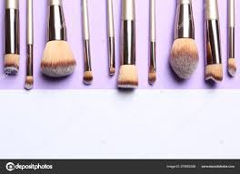 makeup brushes on color background