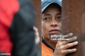 An Asylum seeker cries as she speaks with a translator when asking... News  Photo