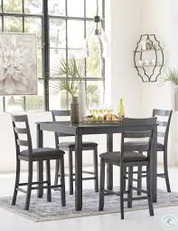 The fully upholstered chairs and bench complete with nailhead trim add a contemporary flair to this dining set. Bridson Gray 5 Piece Counter Height Dining Room Set From Ashley Coleman Furniture