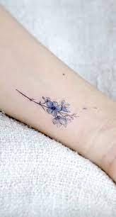 Daisies are one of the most beloved flowers in human history. Small Blue Flower Tattoo On The Wrist Www Otziapp Com Simple Tattoo Designs Simple Flower Tattoo Blue Flower Tattoos