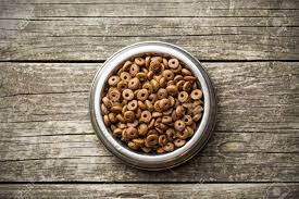 Dry dog food is hard on his digestive tract. Dry Kibble Dog Food In Bowl On Old Wooden Table Top View Stock Photo Picture And Royalty Free Image Image 58845817