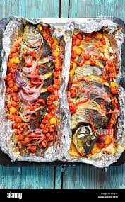 Baked In Foil Whole Fish Carp With Vegetables Stock Photo - Alamy