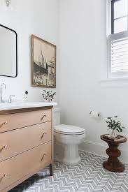 Atlas concorde nash dark oak chevron 32,5x45. A Round Wooden Stool Sits On White And Gray Chevron Floor Tiles In Front Of A White Porcleain Toilet Positioned Powder Room Decor Bathroom Design Chevron Floor