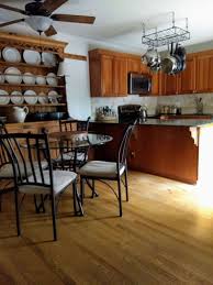 While you can use a similar stained wood floor with this color of cabinetry, in a small kitchen the effect would close the room in. What Flooring Is Best For This Kitchen Designed