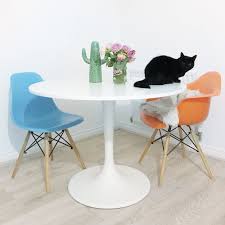 Ikea Docksta Tulip Table With Colourful Mismatched Eames Chairs Cactus Vase And Pink Roses On Top Cat Models Own Tulip Table Eames Chairs Table