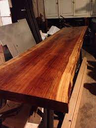 Live edge wood slabs are a great option for table designs and furniture projects. Final Stain On Redwood Slab Future Dining Table Modern Dining Room Lighting Modern Lighting Dining Industrial Kitchen Design