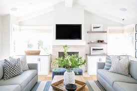 If you have a big family or you love to entertain, add ottomans that can double as seating. Gray Sofas Facing Each Other On Blue Stripe Rug Transitional Living Room