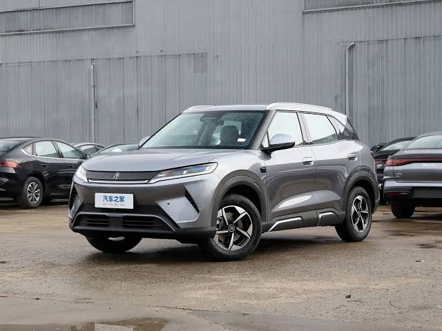 The sleek exterior profile of the factory-fresh 2026 BYD Yuan Up crossover SUV., AI generated