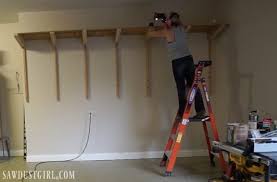 Each shelf can the be place in position on the wall and supported on the loose end with a 2x4 acting as a pillar. Building Garage Shelves Cantilevered Shelf Brackets Sawdust Girl