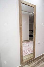 Does the room seem dark and small? Tall Full Length Mirror Hanging On Wall In Bedroom Of Luxury Stock Photo Picture And Royalty Free Image Image 158065552