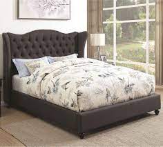 This classic upholstered platform bed features a button tufted headboard and low profile footboard style frame, with wood slats and exposed feet for support. Newburgh Upholstered Bed With Button Tufted Headboard