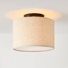 This type of light drops from the ceiling a bit and leaves some space between the ceiling and the fixture. Fabric Shade Flush Mount Lighting Drum