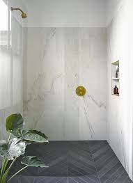 Marble Effect Porcelain Tile And Brass Accents In This East London Shower Patterned Bathroom Tiles Shower Floor Tile Shower Remodel