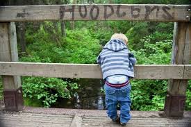 Perfect for keeping the boys' pants up. Young Boy Looking Over A Bridge With His Pants Falling Down And The Sign Hoodlums Over His Head Stock Photo Dissolve