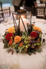 Fall Reception Centerpiece With Red Orange And Yellow Flowers Greenery And Black Lan Fall Reception Centerpieces Autumn Reception Fall Wedding Centerpieces