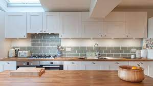 A pale wax finish would be a beautiful addition to a kitchen with dark charcoal cabinets, while a dark stain could set off cream or stone cabinets to perfection. White Shaker Kitchen With Wooden Worktops Burwash East Sussex