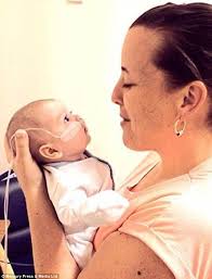 Mother 'advised to abort unborn son' holds him for the first time