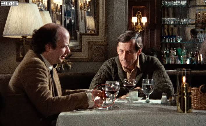 In "My Dinner with Andre" (1981) the waiter wanted to serve the amaretto  before it was ordered. Then he finally serves it after Wally gives his  speech about the future/science/omens etc. :