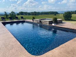 The water's color matches the teal cushions and upholstery of the wooden seater as well as the teal toned floor mattresses. Swimming Pool Fountains Bubblers Waterfalls Latham Pools